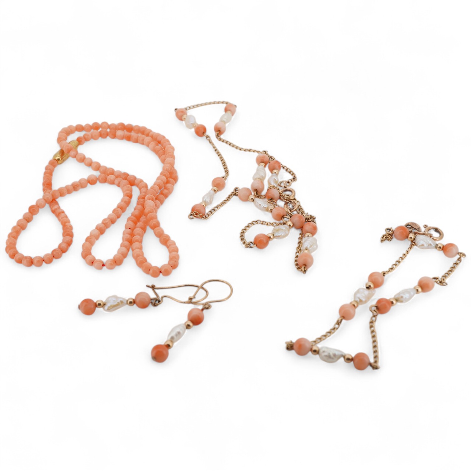 A suite of modern 9ct gold, coral and baroque pearl set jewellery, comprising a necklace, 38cm, a bracelet, 16cm and a pair of drop earrings, together with one other coral bead necklace.